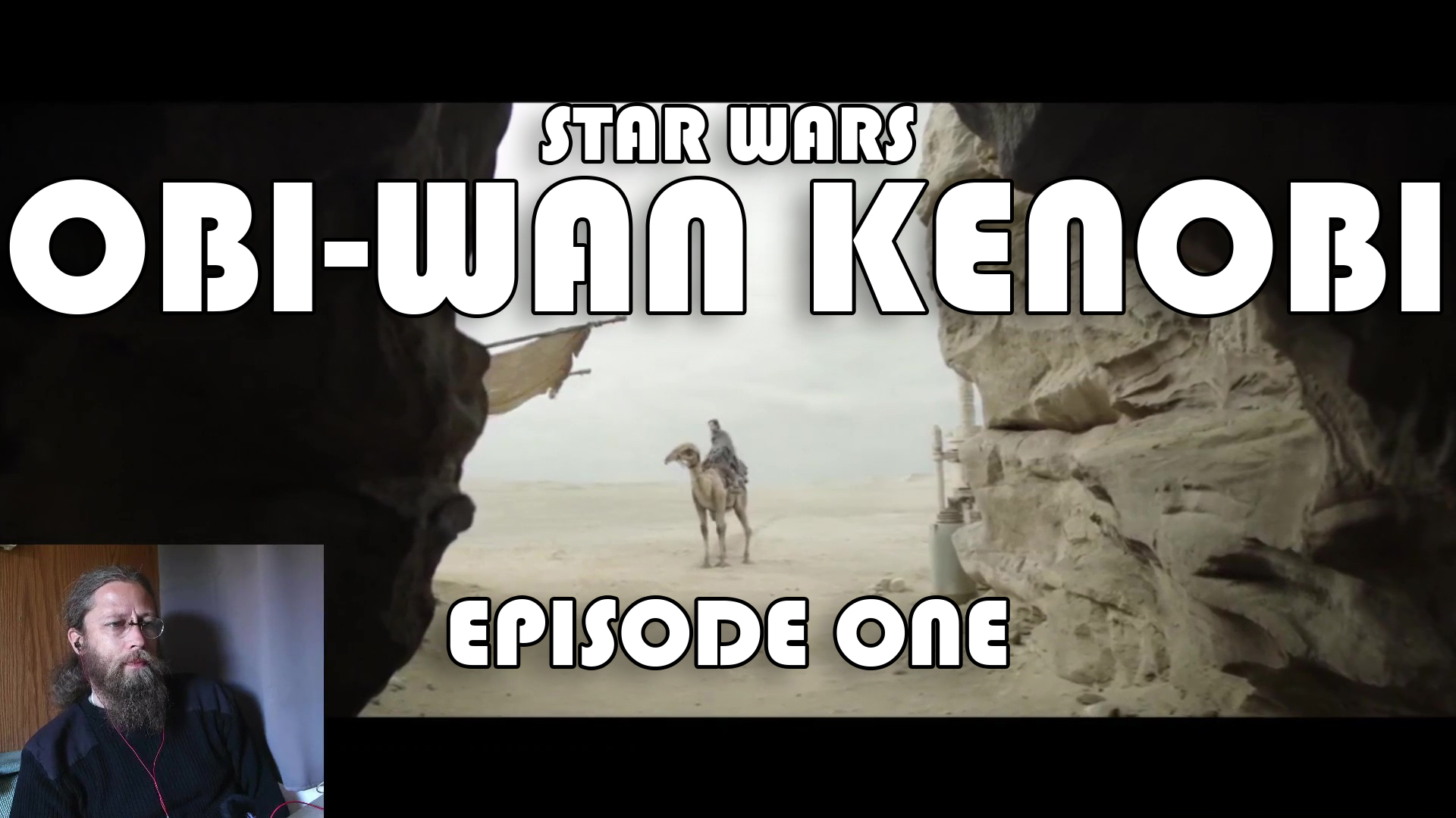 Video thumbnail for Episode One of Star Wars' Obi-Wan Kenobi series. Image is of Obi riding a camel in the distance, he's in a desert approaching the narrow cave entrance that we are viewing out from. In the lower left corner is an overlay video of me watching the episode.